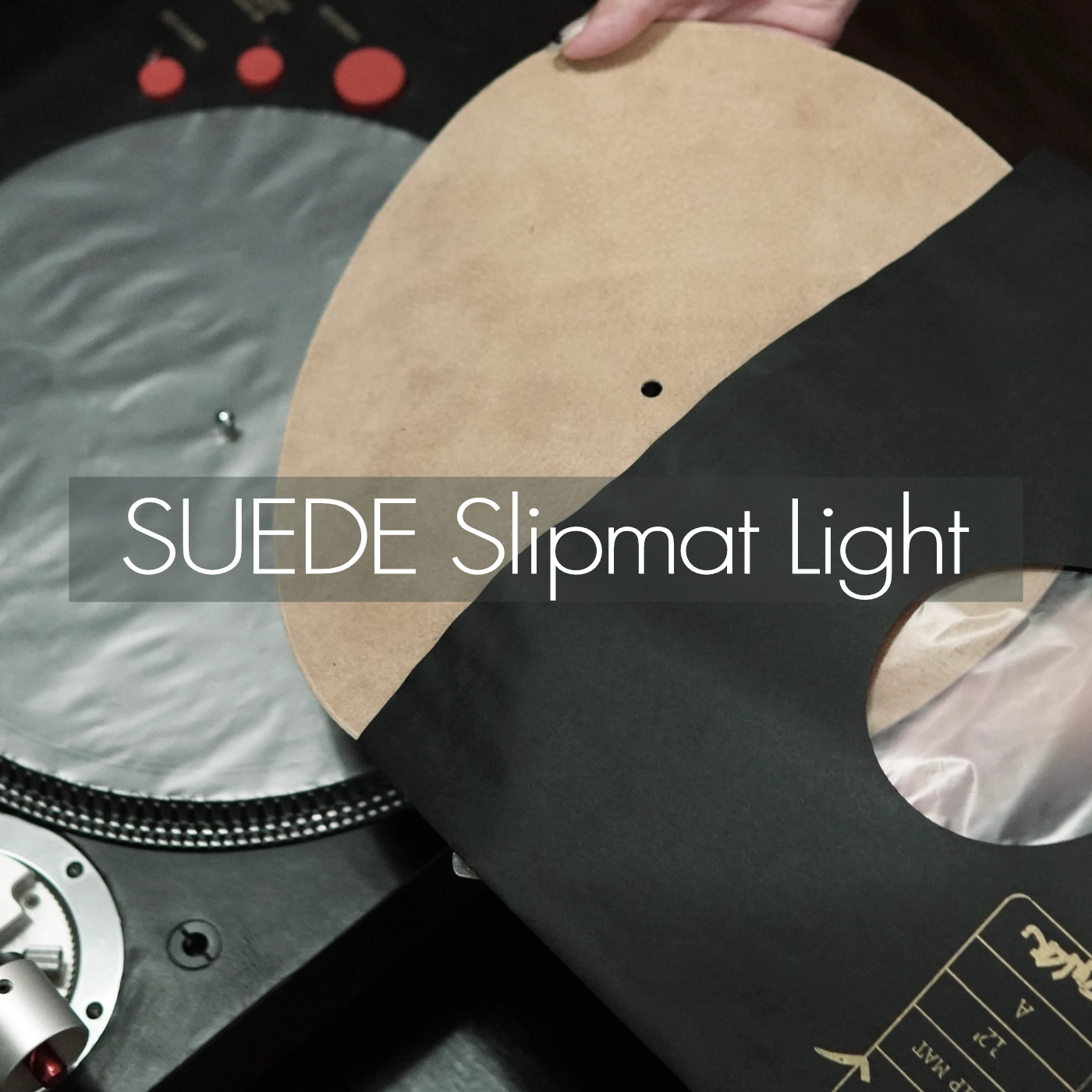 A suede slipmat held above a turntable